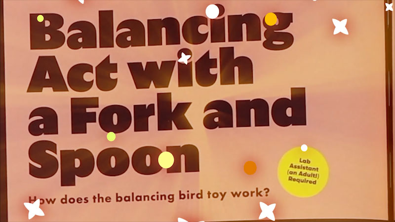 Still image from: Emily's Science Lab: Gravity Defying Fork and Spoon Balancing Trick
